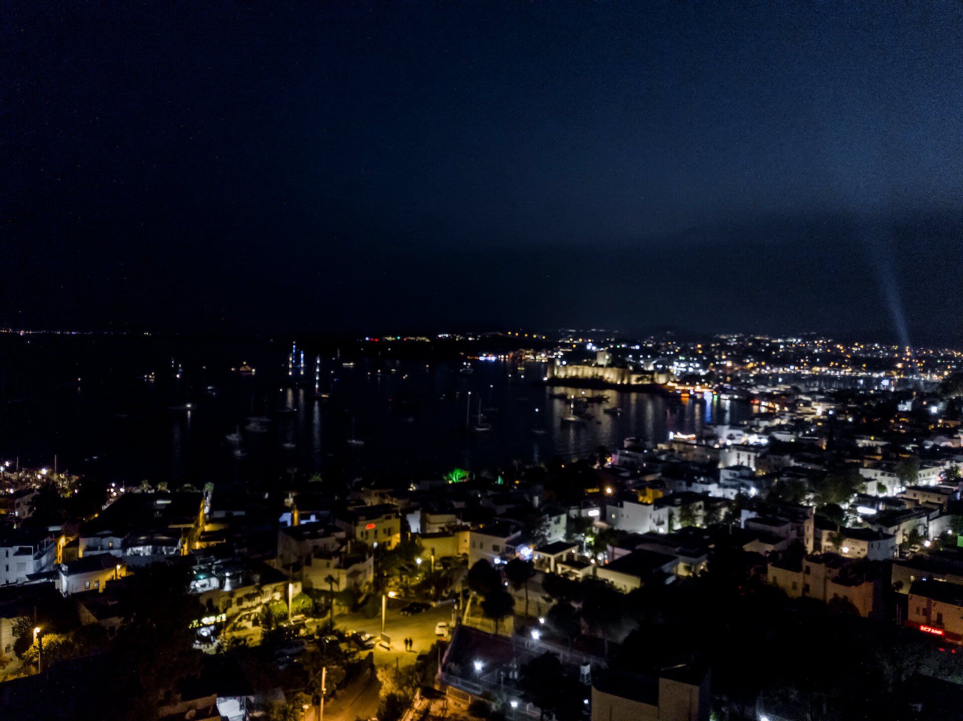 An aerial view of a city at night with lots of lights.