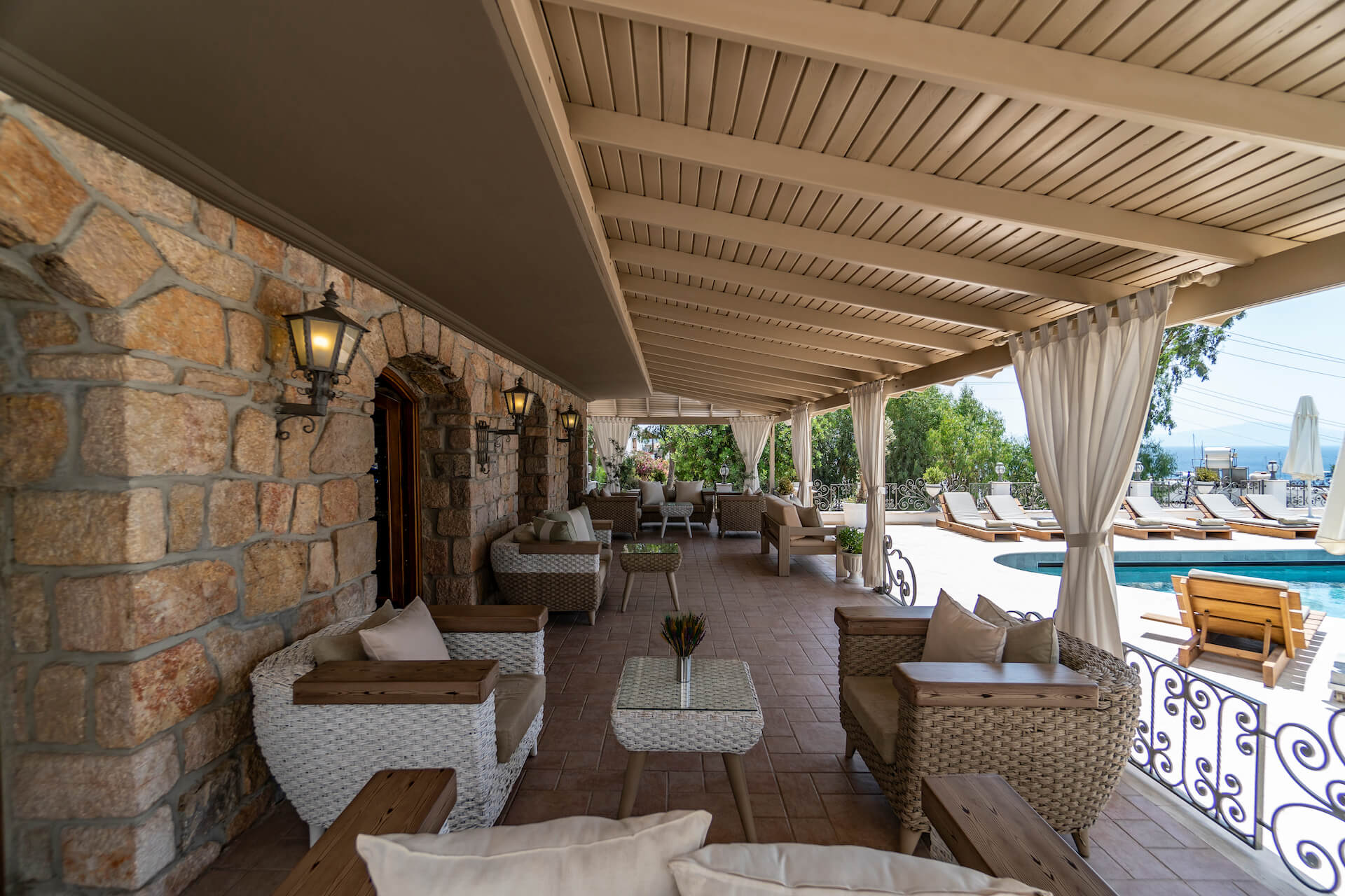 There is a large patio with a swimming pool in the background.