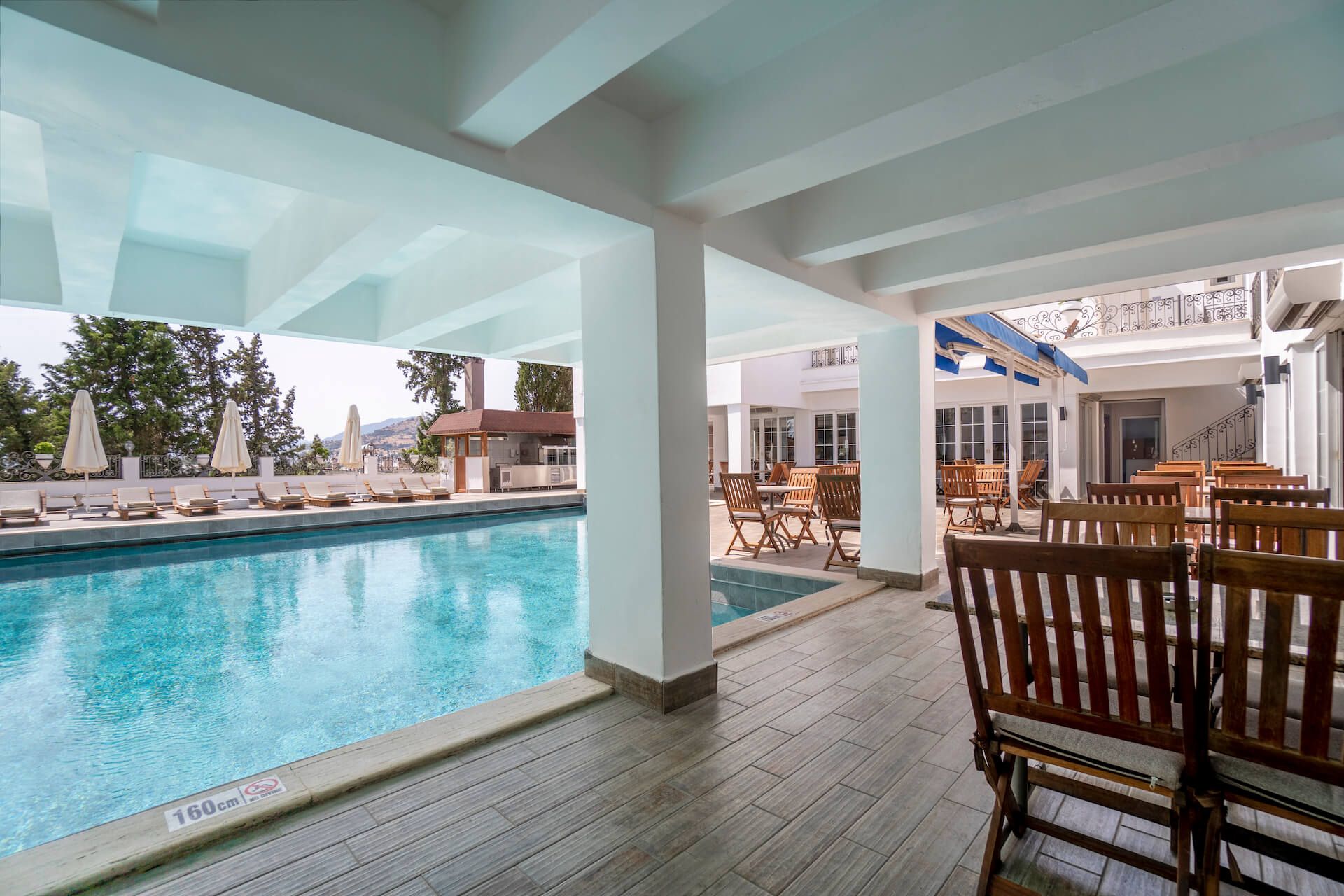 There is a large swimming pool in the middle of a building.