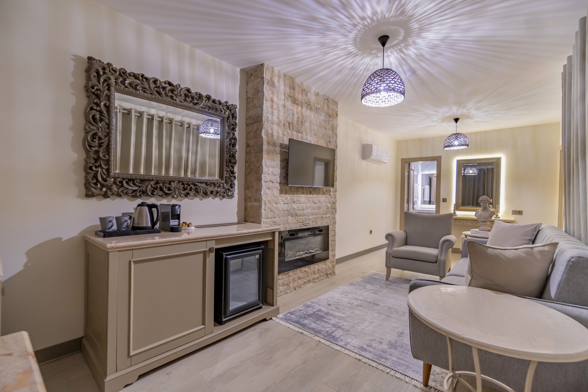 A living room with a couch , chair , table and fireplace.