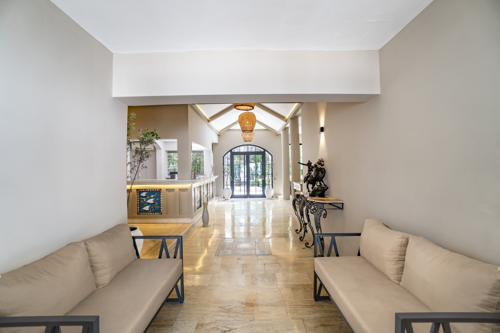 A long hallway with a couch and chairs in it