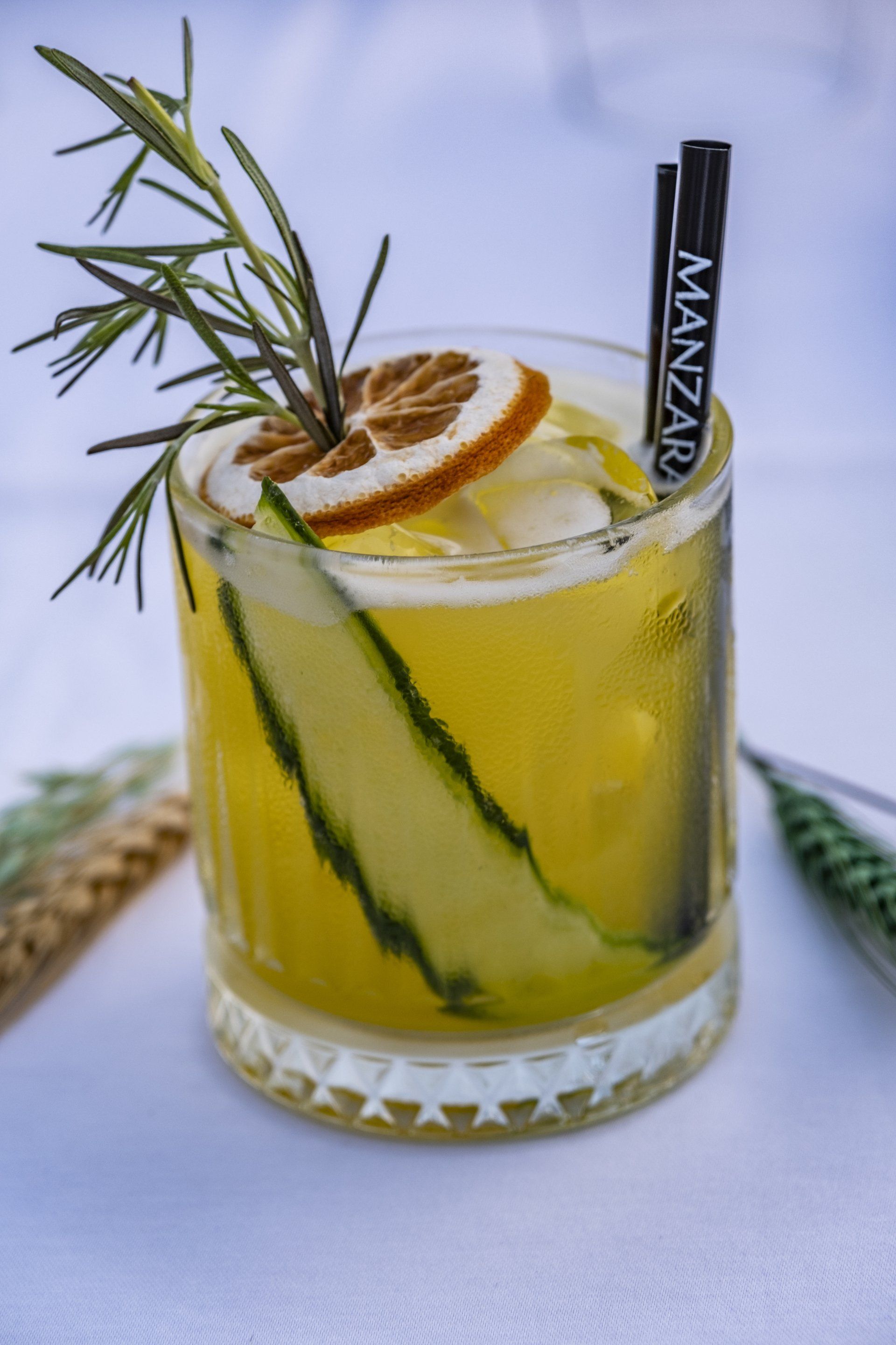 A drink with a straw that says manzano on it