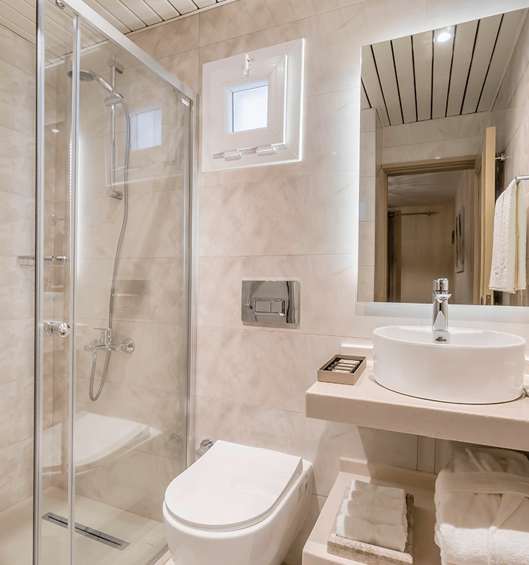 A bathroom with a toilet a sink and a shower