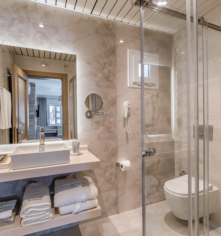 A bathroom with a toilet a sink and a mirror