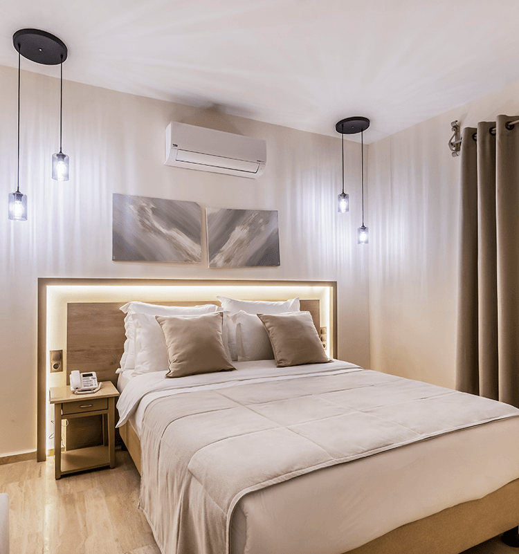 A bedroom with a large bed and a nightstand