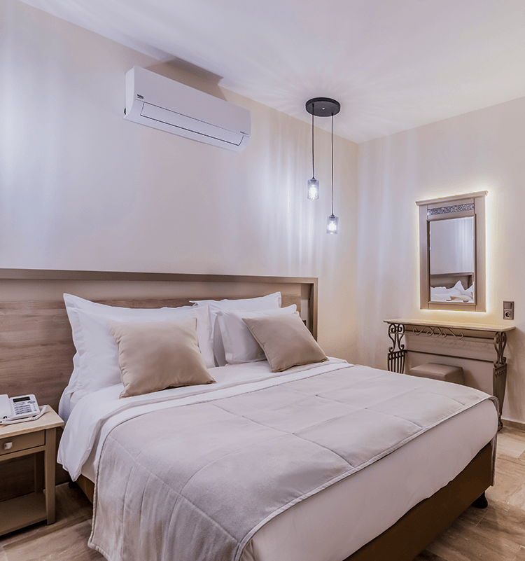 A hotel room with a large bed and a mirror