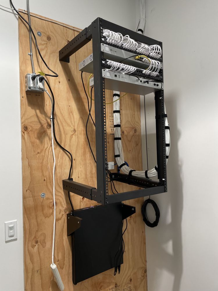 A server rack is hanging on a wooden wall.