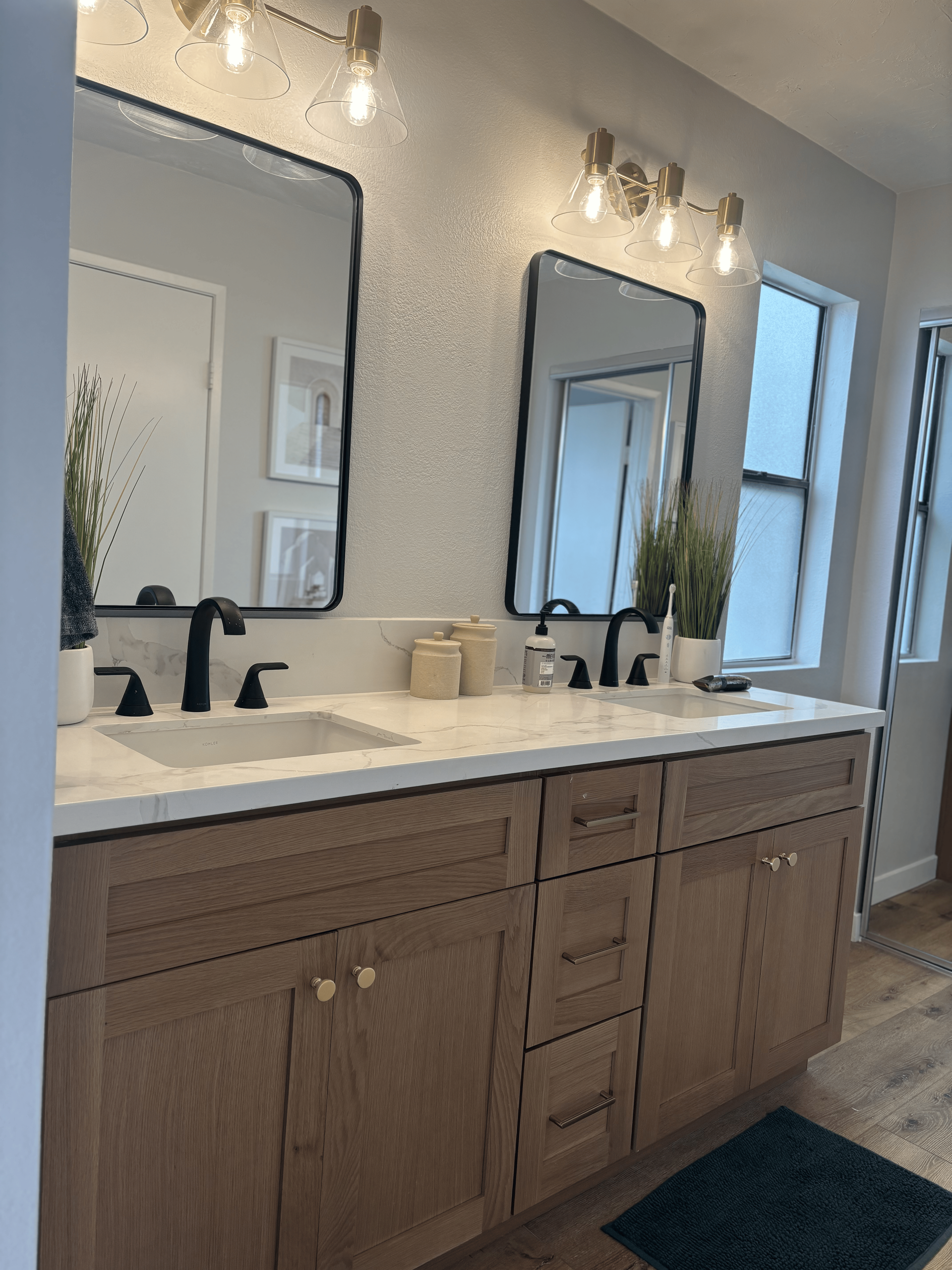 A bathroom with two sinks and two mirrors.
