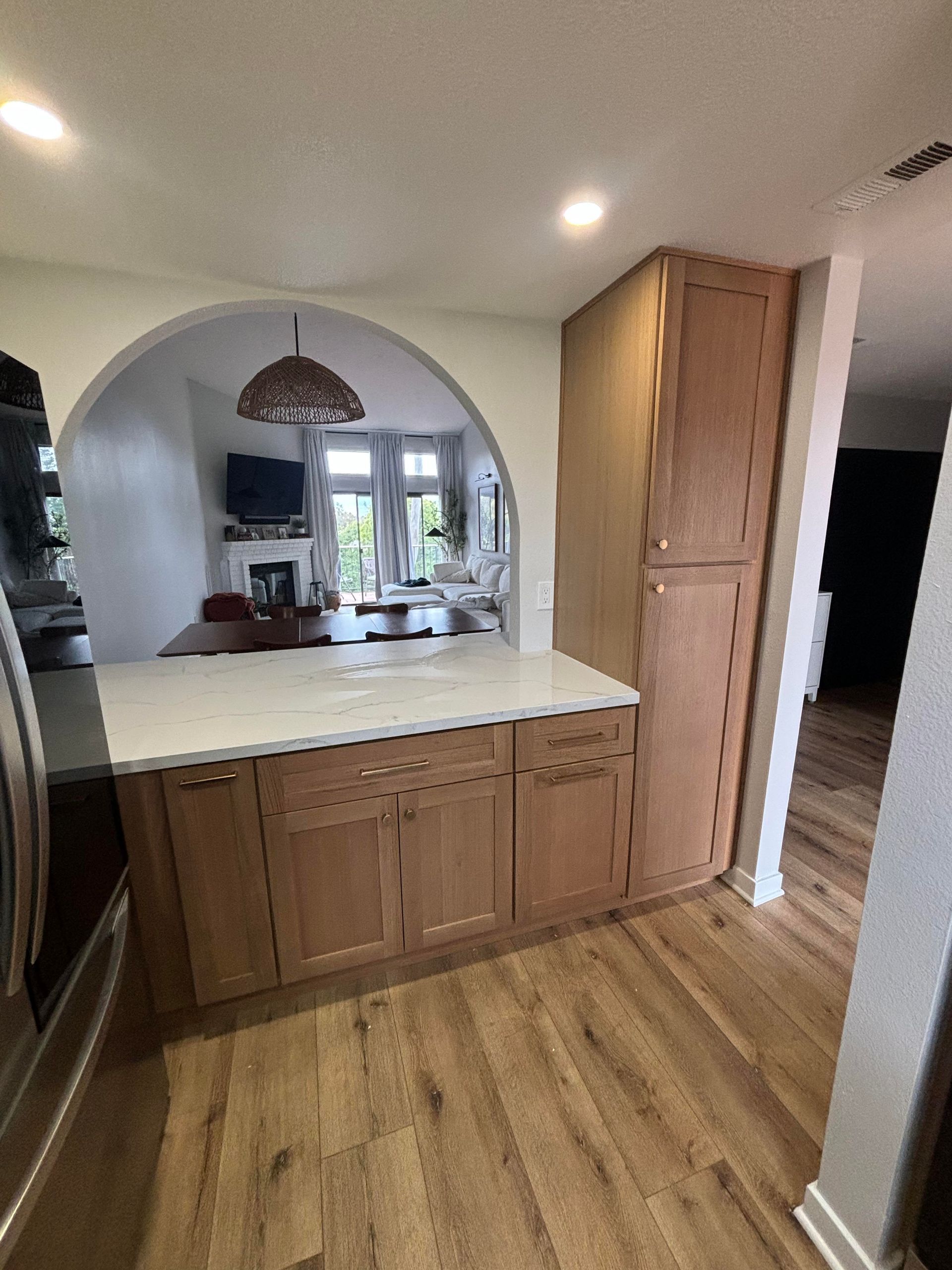 A kitchen with a coffee mug on the counter and a stove.