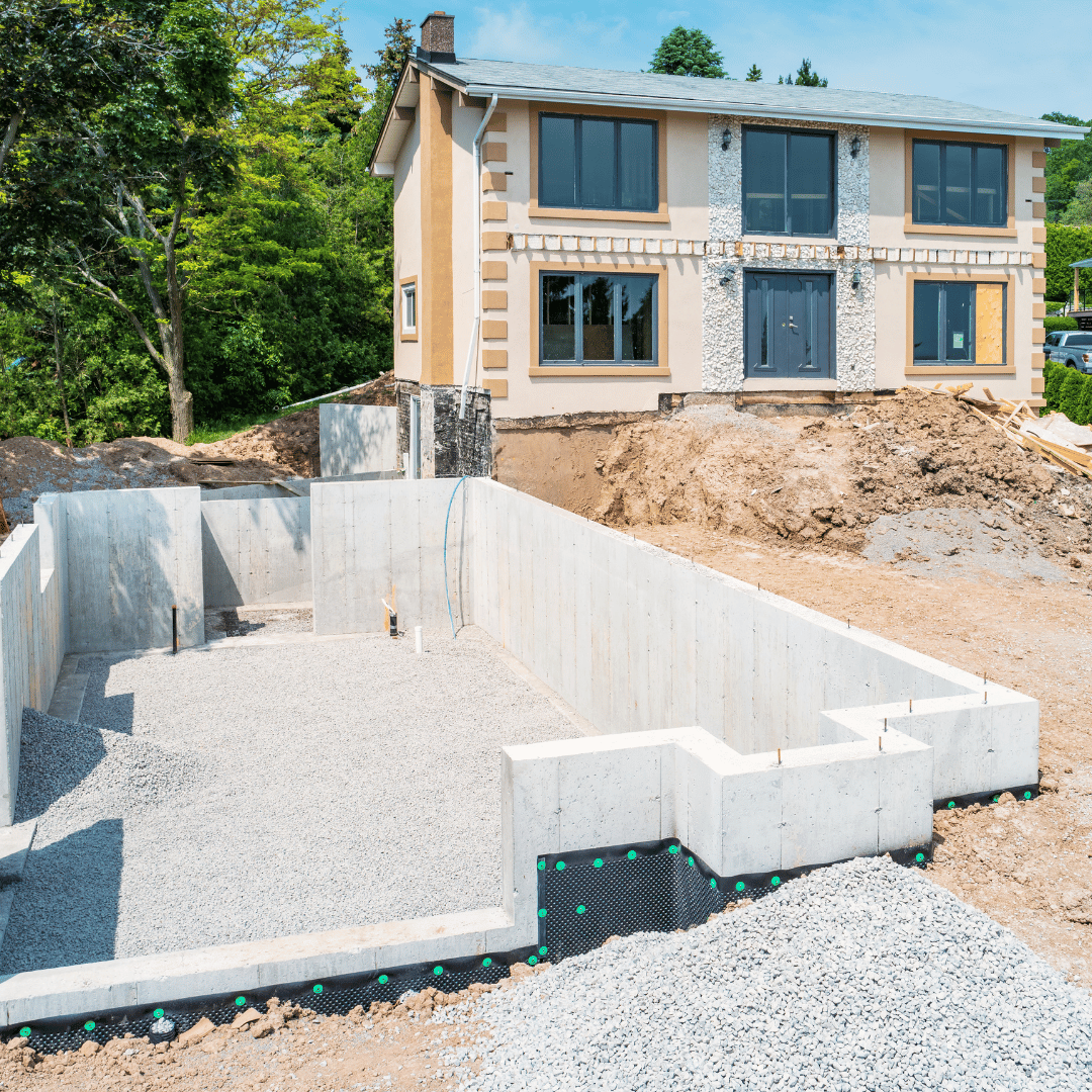 A house is being built on top of a dirt hill.