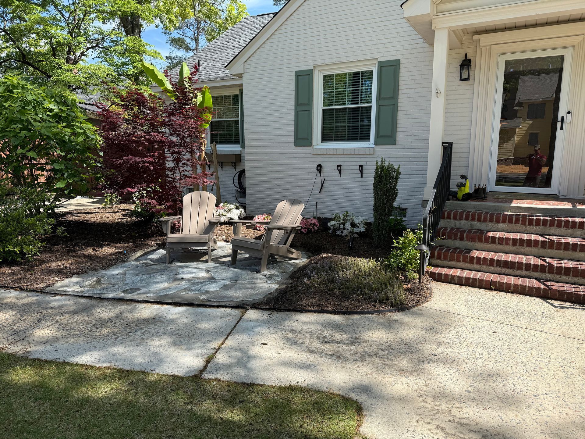 A man wearing a hard hat and goggles is standing in a room.