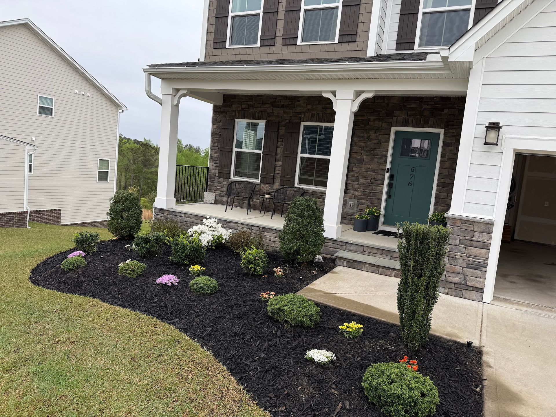 Two men are standing in an empty room with black walls