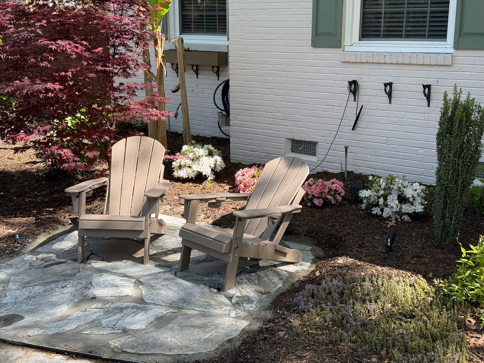 A construction worker wearing a blue hard hat is working on a roof