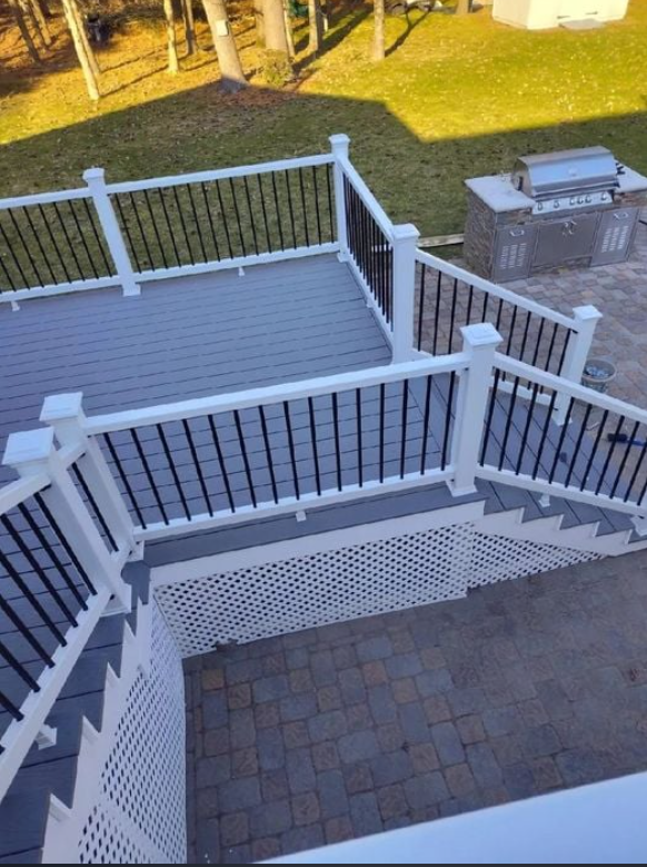 An aerial view of a deck with stairs and a grill.