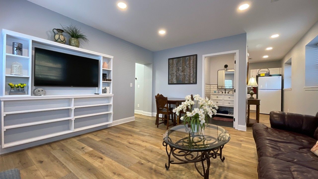 A bedroom with a bed and a ceiling fan
