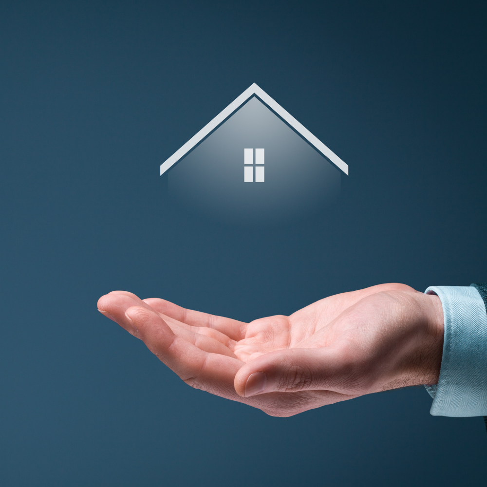 A hand is holding a house that is floating in the air