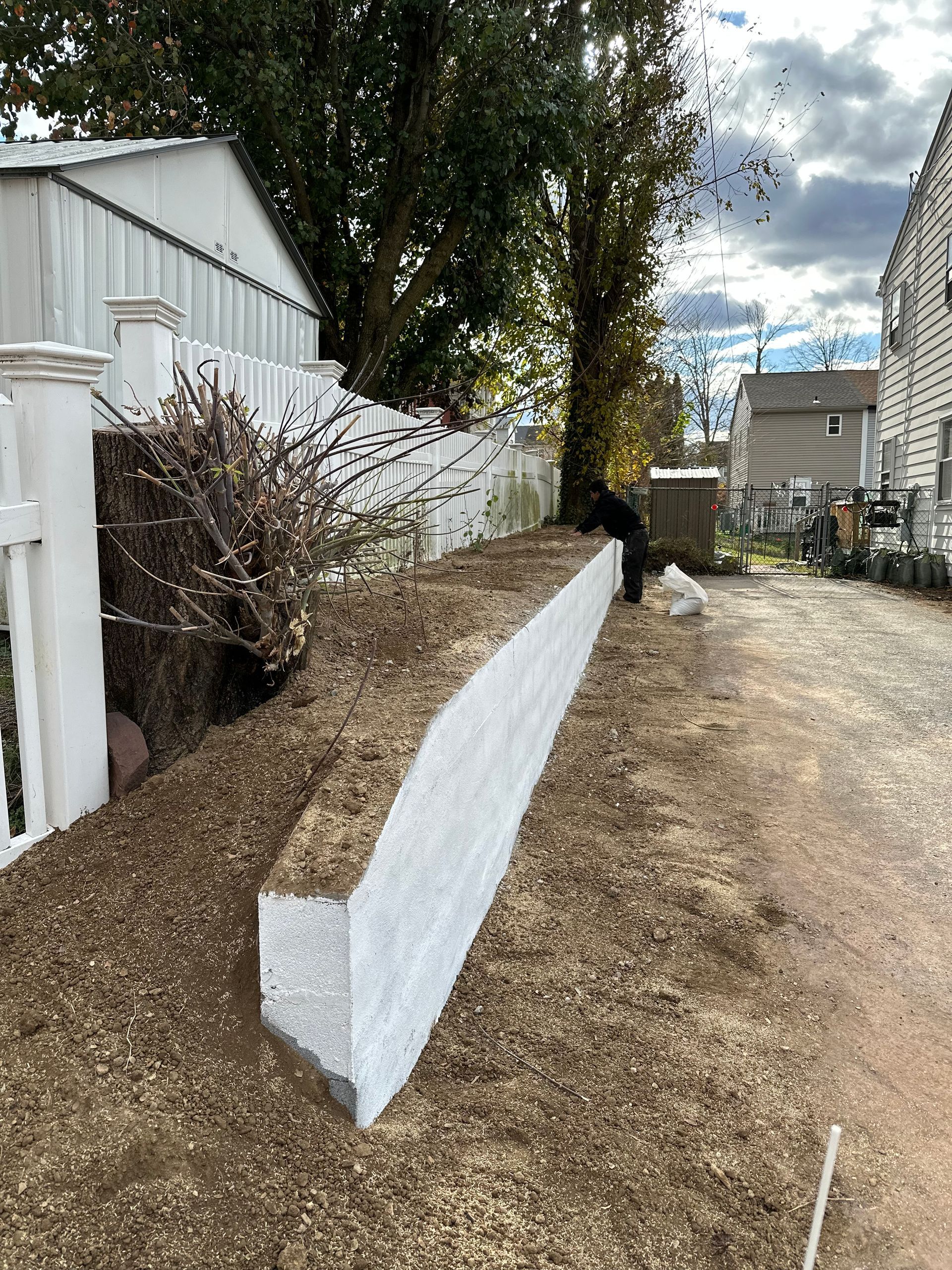 A brick wall is being built on a construction site.