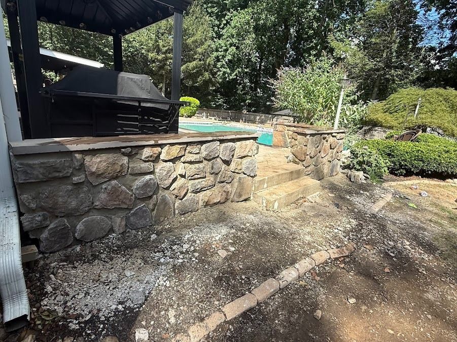 An empty room with a wooden floor and a ladder.