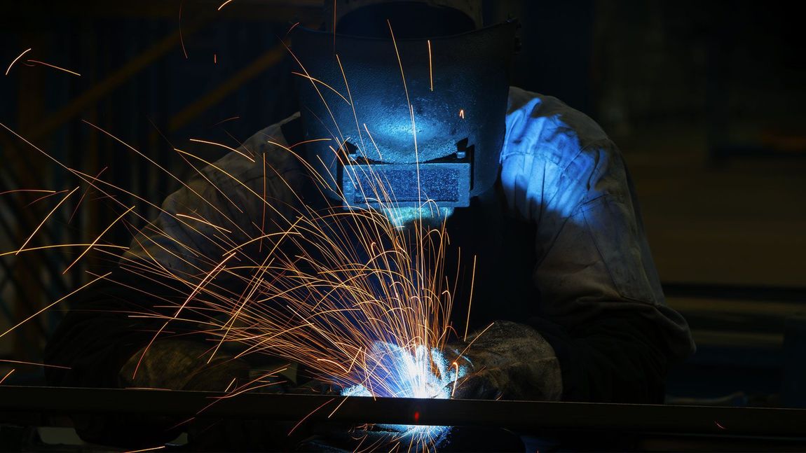 Welders Working at the Factory Made Metal