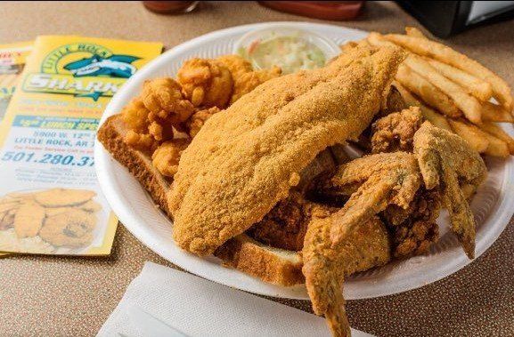 A white plate topped with fried fish and french fries