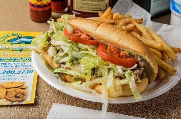 A sandwich and french fries on a white plate