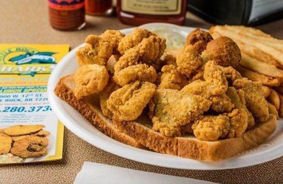A white plate topped with fried shrimp and french fries