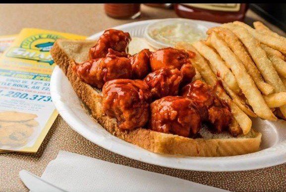 A white plate topped with chicken wings and french fries