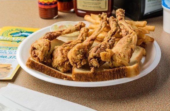 A white plate topped with fried oysters and french fries