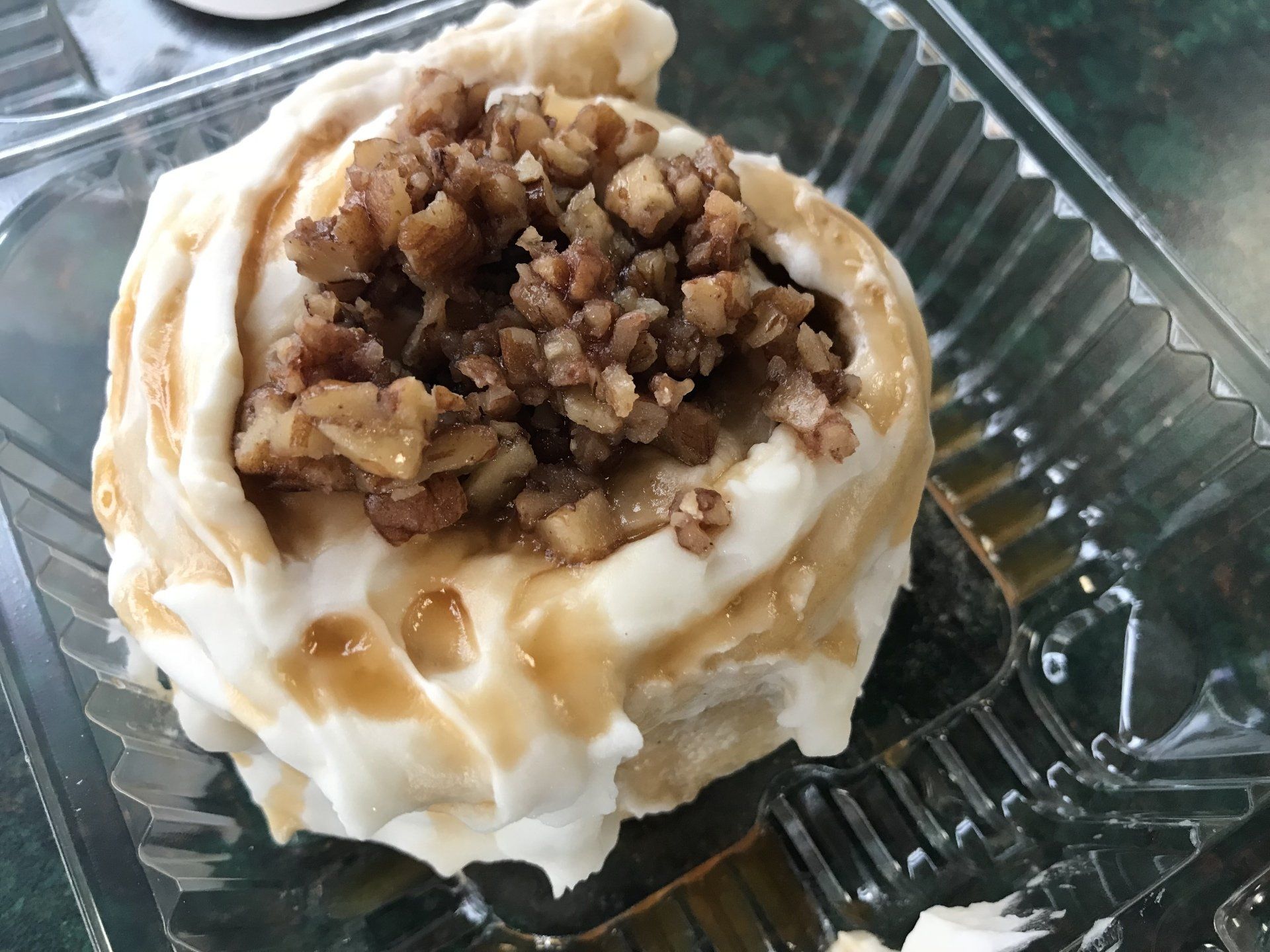 A close up of a dessert in a plastic container on a table.