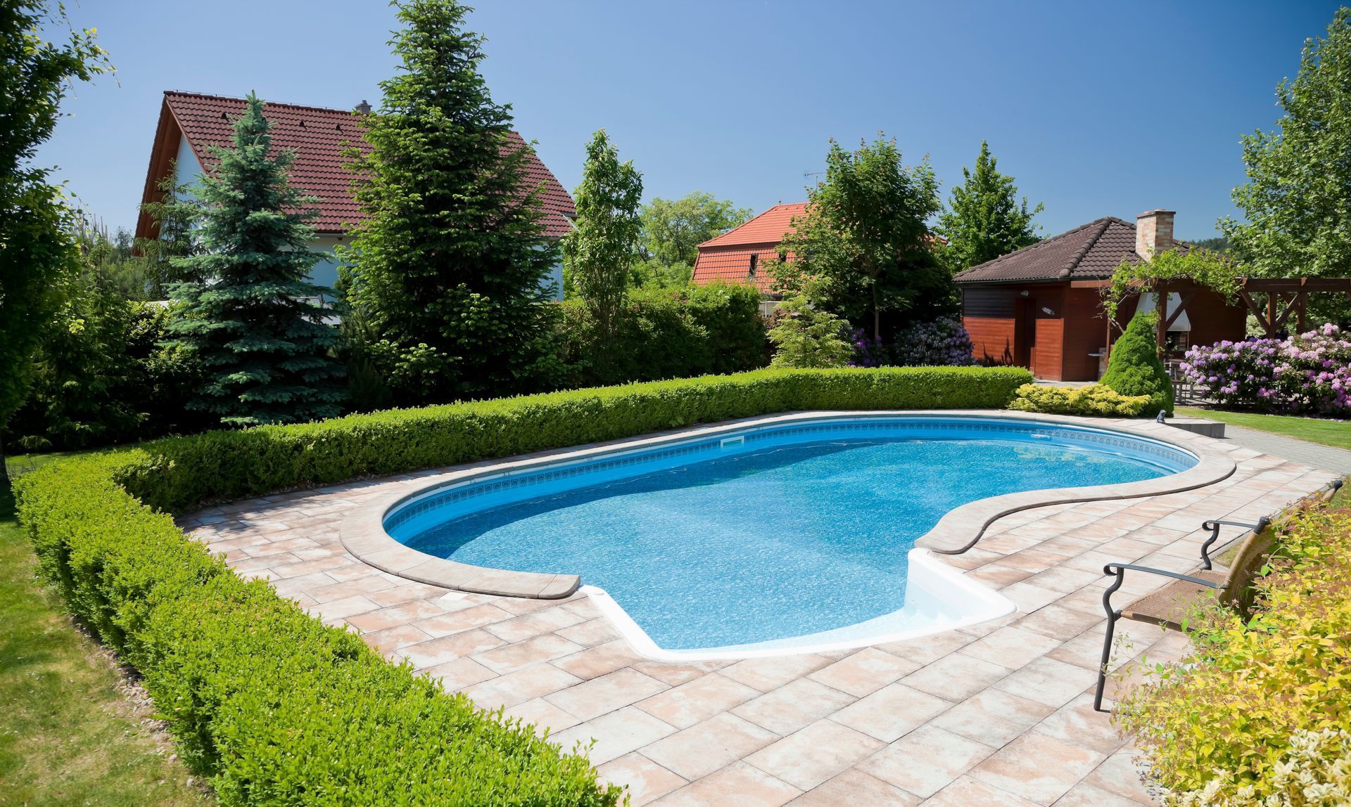 A large swimming pool in the backyard of a house