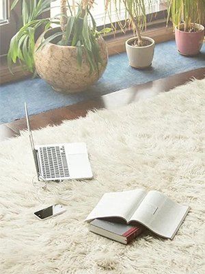 Laptop and Books on the Carpet – Upholstery in Byron Bay, NSW