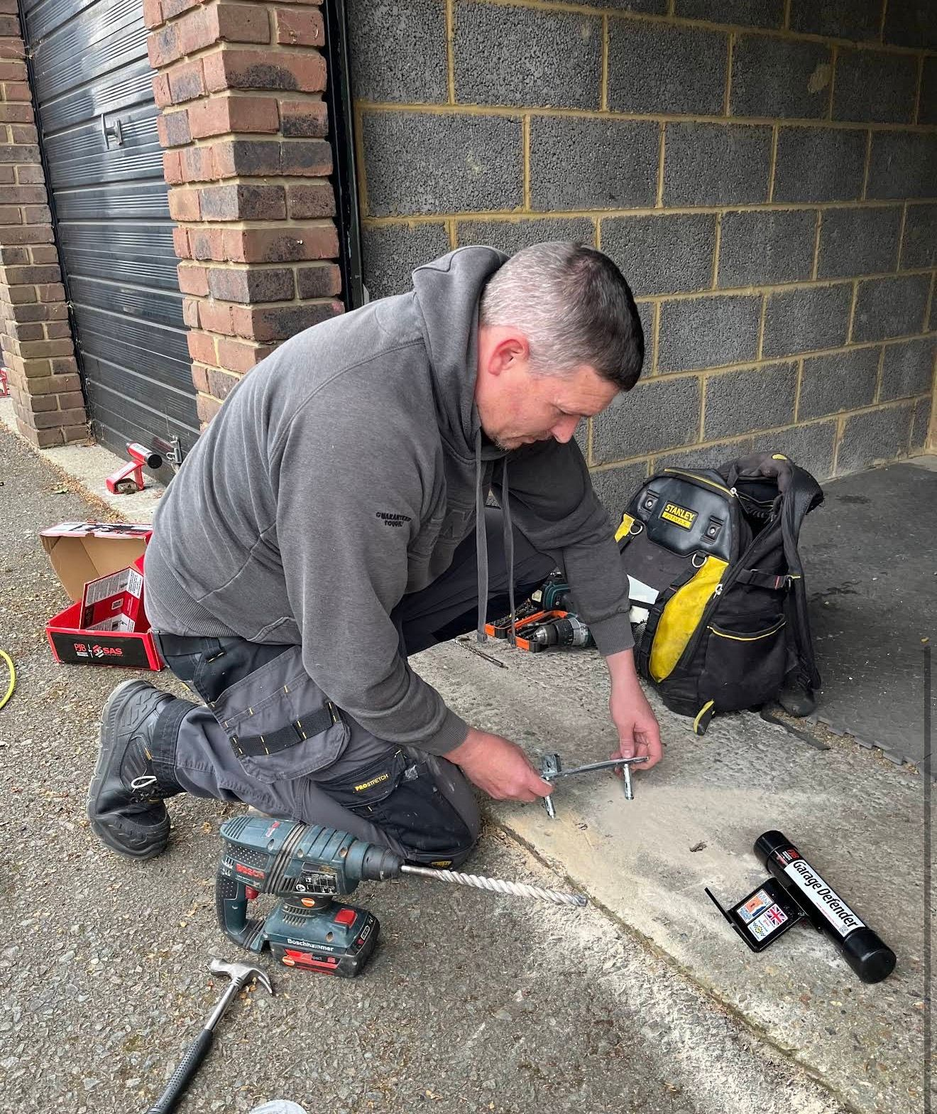 Garage defender repair and replacement installation in Lee by Gerry from The Key Locksmith fitting a heavy-duty garage security defender to secure an up-and-over garage door.