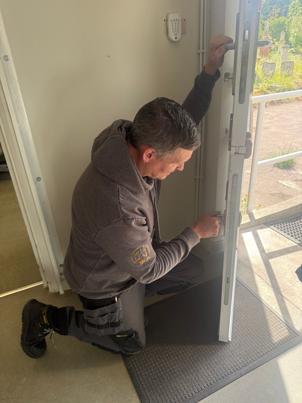 Gerry from The Key Locksmith repairing a uPVC door in London