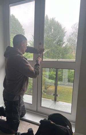 Locksmith working on a jammed balcony door lock in Bromley using non-destructive entry methods on an older aluminium door mechanism during a residential locksmith callout by The Key Locksmith.