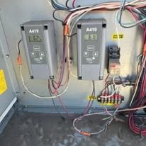 A bunch of wires are connected to a wall.