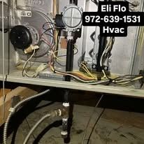 The inside of a heating and cooling system with a lot of wires coming out of it.