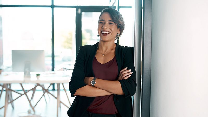 Picture of a female founder smiling in a white office background