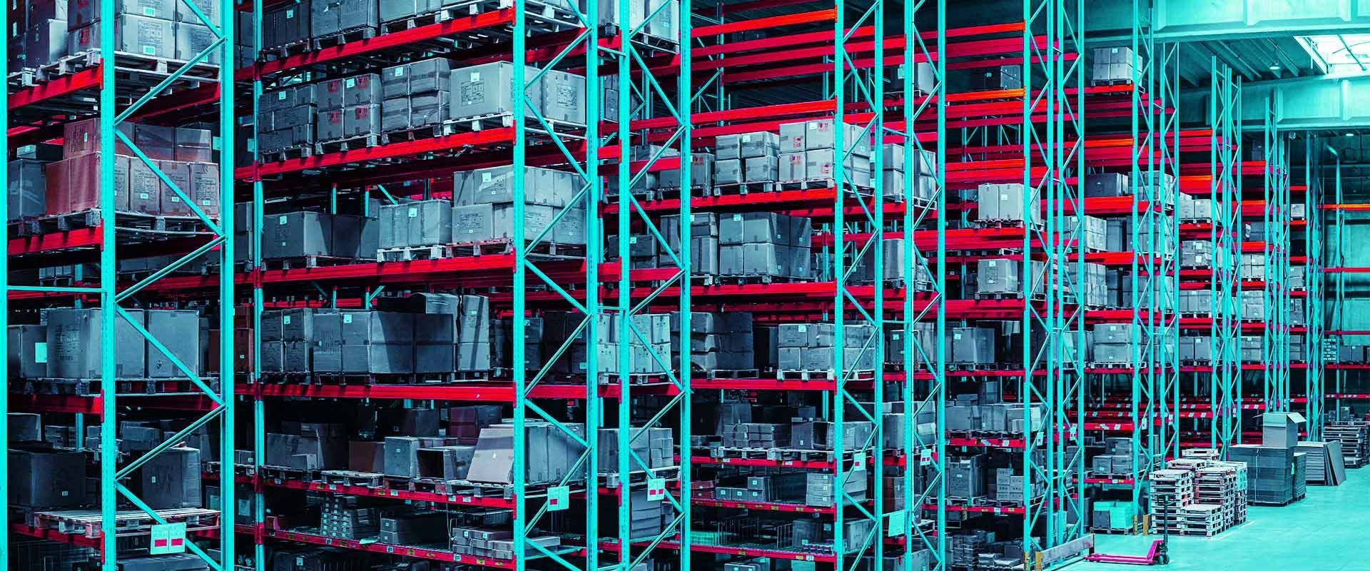 A line of floor to ceiling shelves in a warehouse