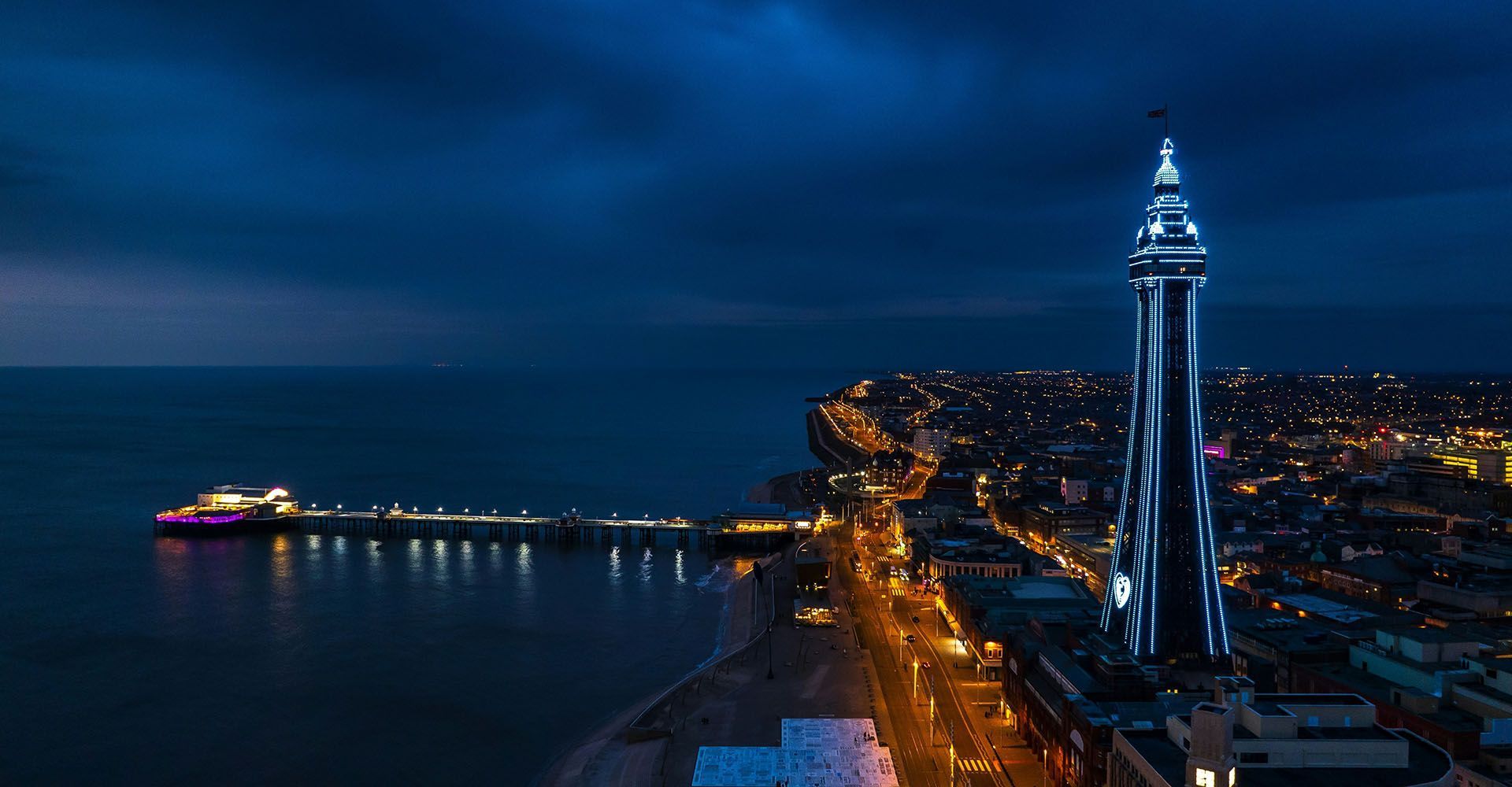 Blackpool at night with the pier in prominent view.