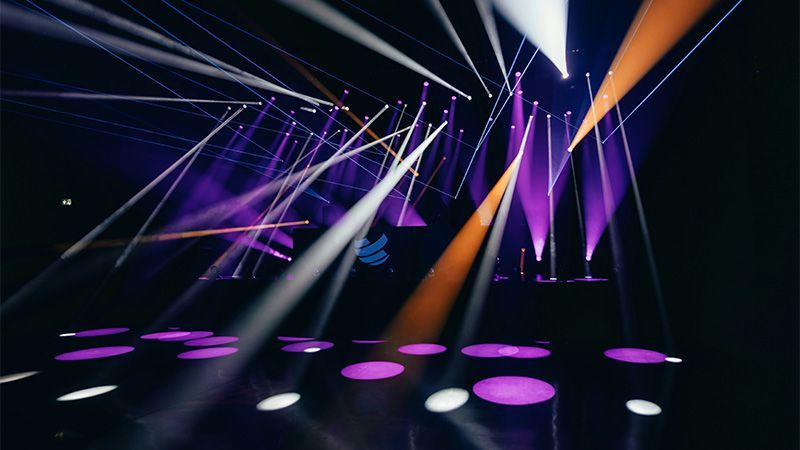 Orange and white spotlights on a purple stage