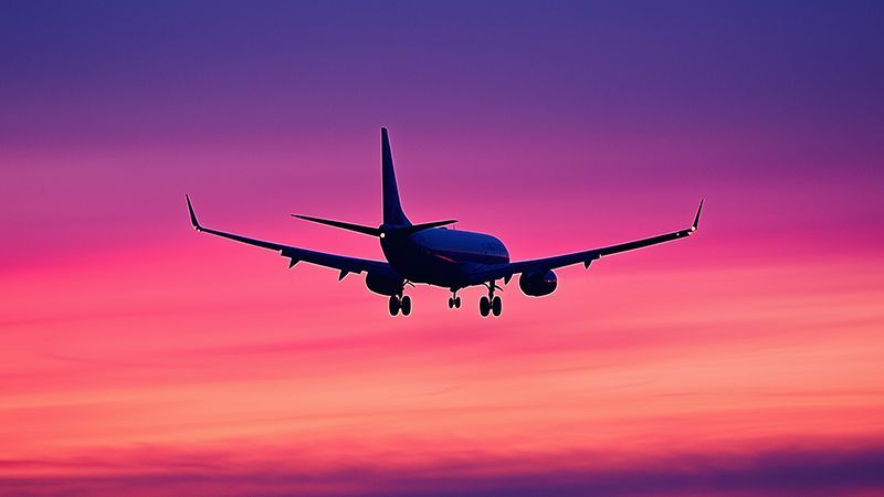 Silhouette of 737 plane in a neon sky