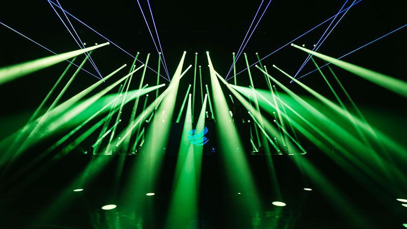 Criss-cross of Green Spotlights on a Stage