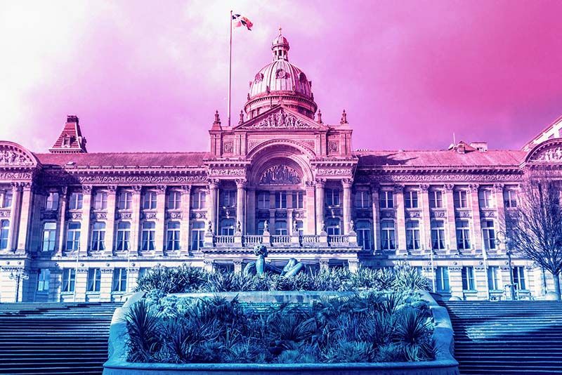 A stately council building in England with a neon tint