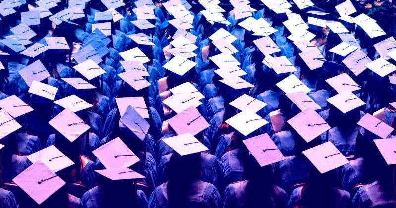 Aerial shot of students wearing mortarboards - neon tint added