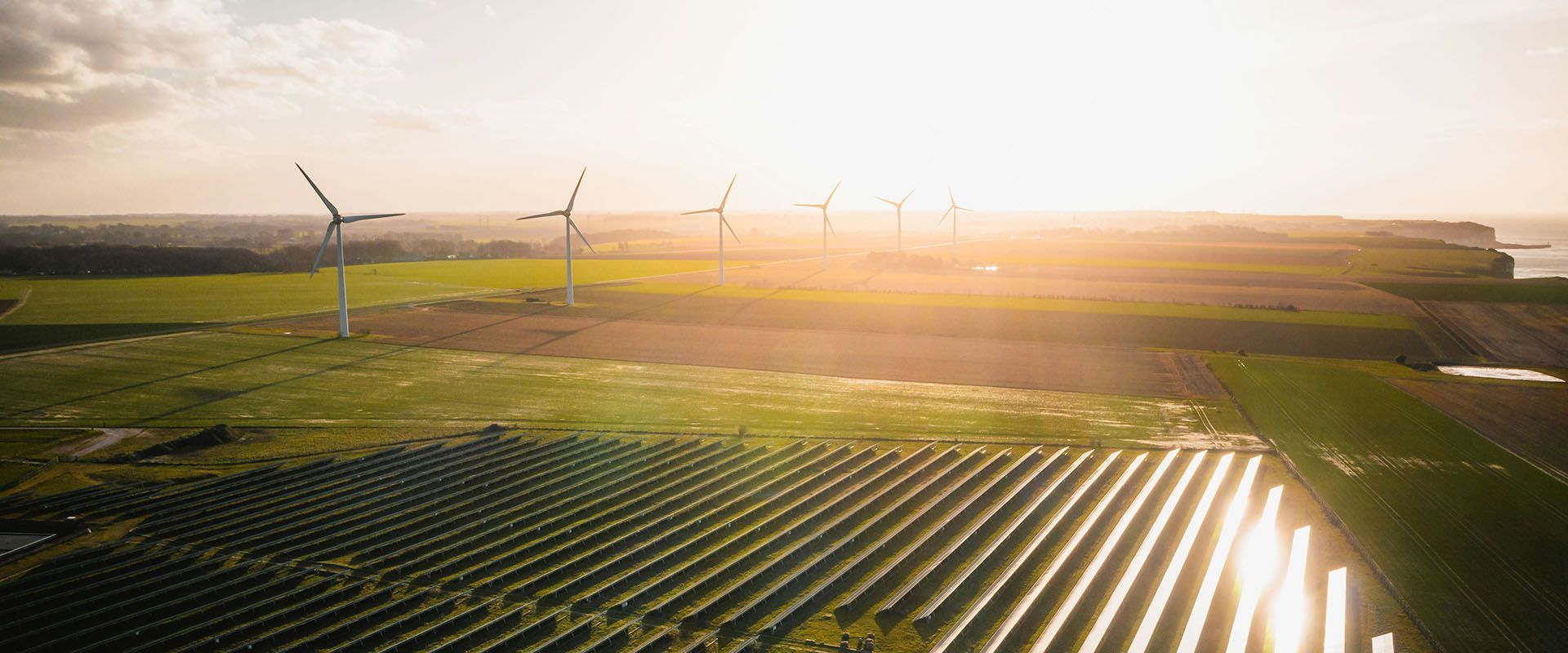 Wind farms  and solar panels in the countryside at dawn
