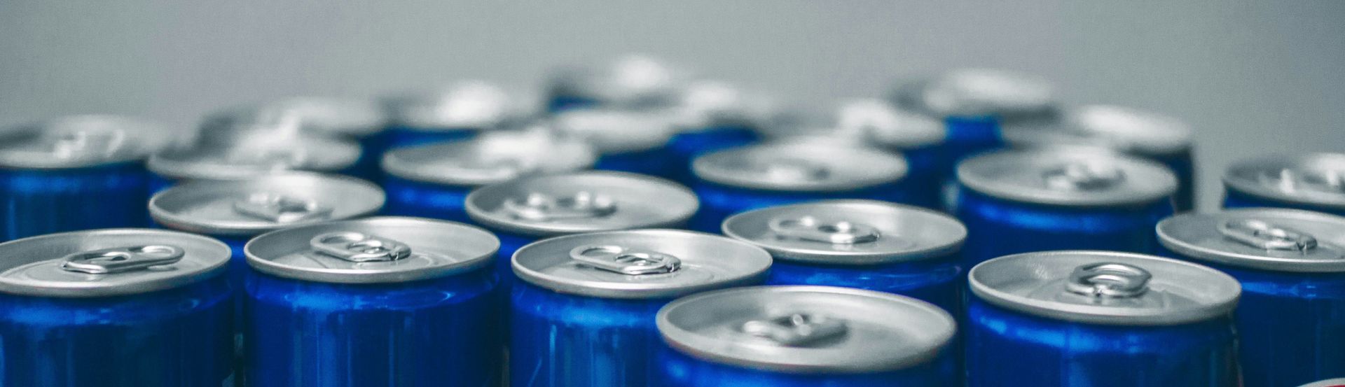 The tops of blue metal drinks cans.