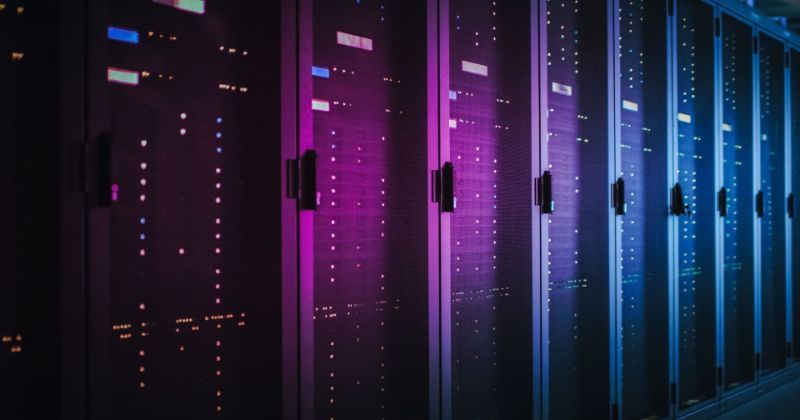 A row of data centres under neon purple and blue light.
