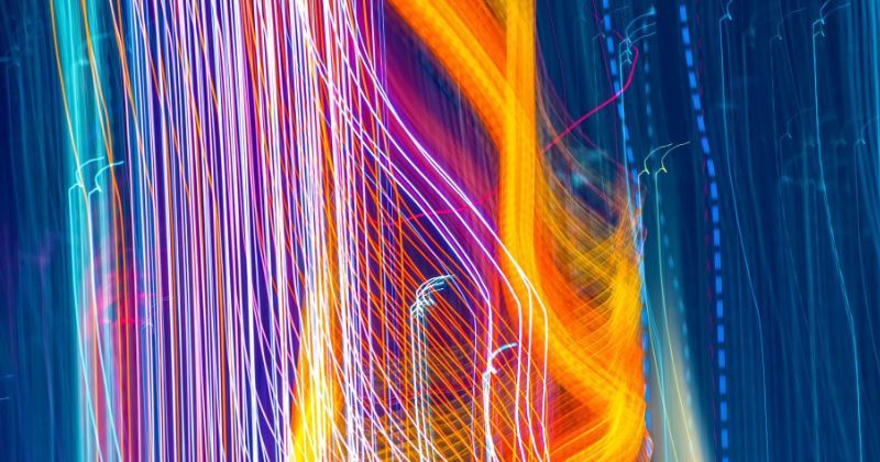 Abstract image of lines and light tracing in neon blues, red, yellow and pink