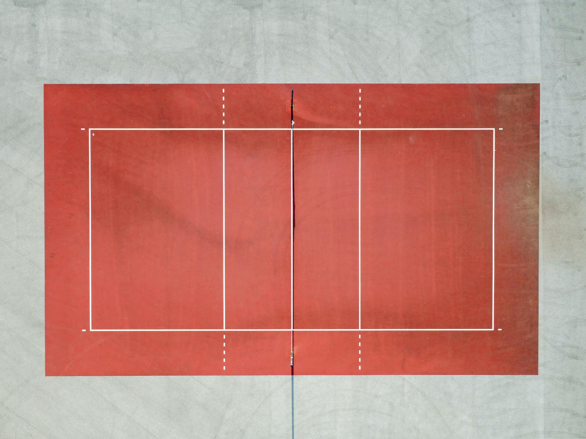 An empty clay tennis court from above
