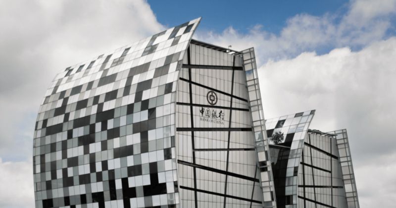 A black and white skyscraper against the sky.